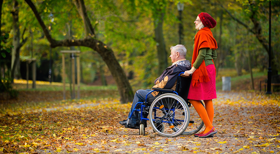 man on wheelchair with young woman